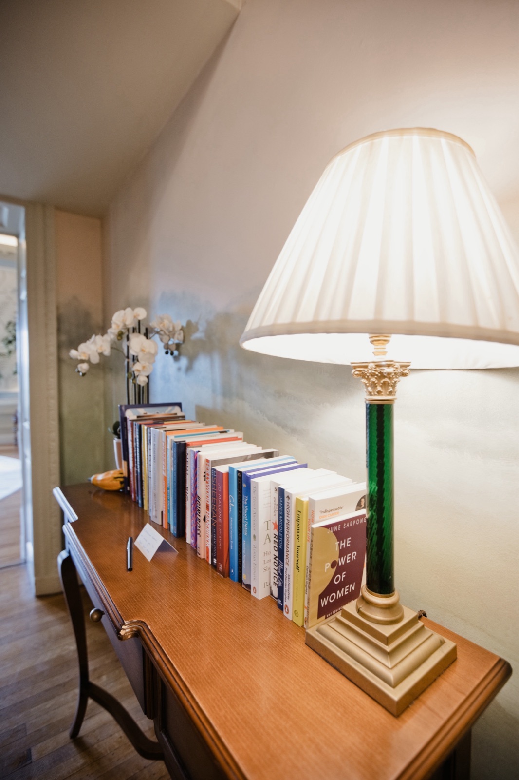 Books by the guests of The Hedsor Hundred on a console table at Hedsor House, including Empower Yourself by Xenia Tchoumi, now kept permanently at Hedsor House, My Story by Jo Malone and The Good Ancestor by Roman Krznaric