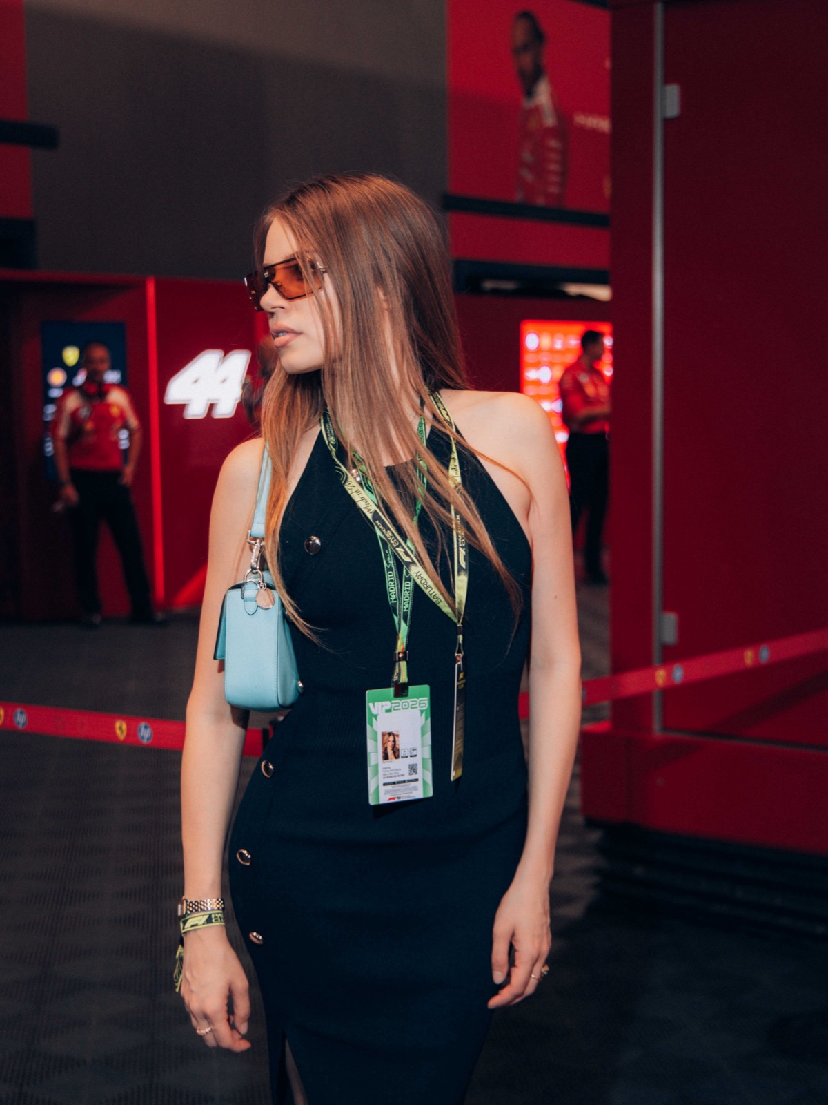 Xenia Tchoumi with her F1 Paddock Club VIP 2026 pass at Scuderia Ferrari in the paddock of the Madrid Grand Prix, number 44 behind her