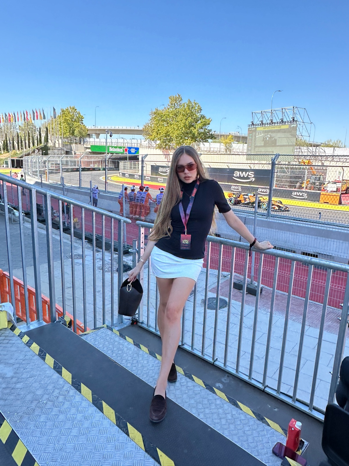 Xenia Tchoumi on a VIP platform above the Madring on race day at the F1 Spanish Grand Prix 2026 in Madrid, as an official guest of Meta, a Formula 1 car passing below