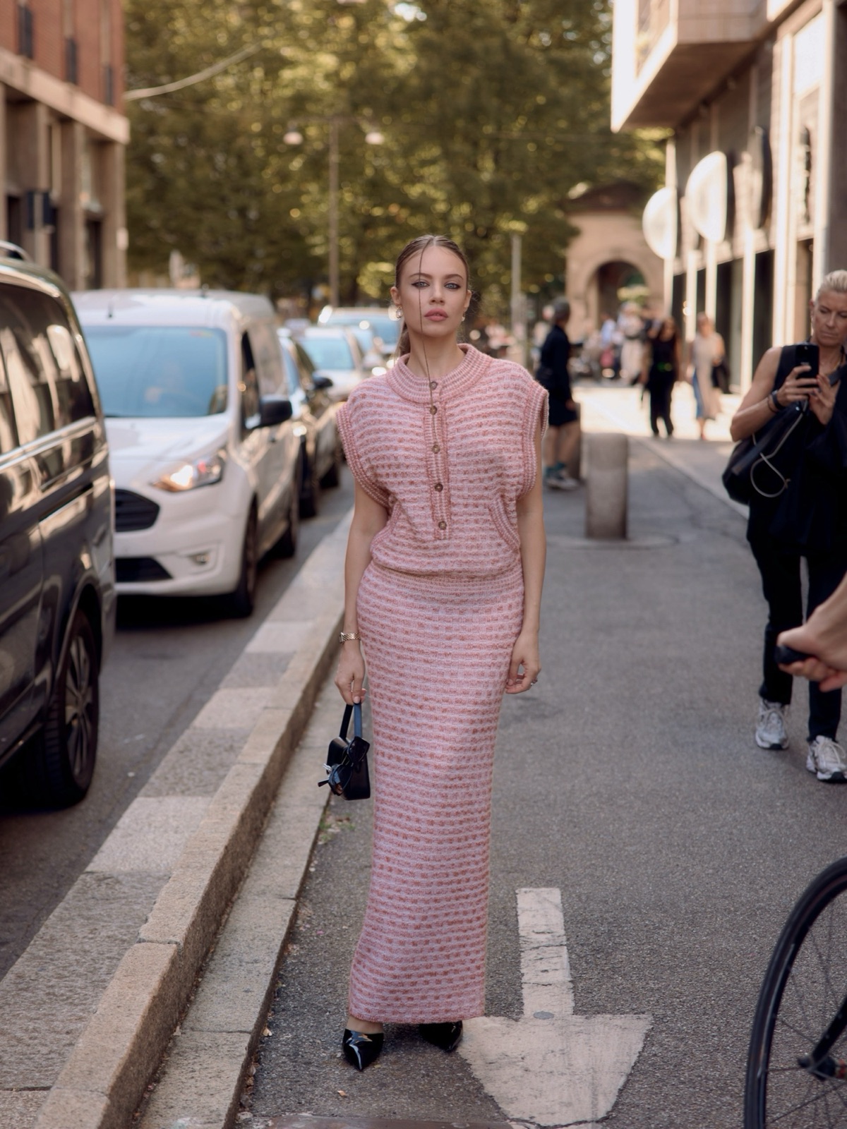 Xenia Tchoumi street style at Milan Fashion Week 2026, wearing a pink Missoni knit top and maxi skirt on her way to the Missoni Spring/Summer 2027 show