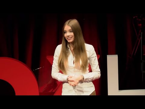 Xenia Tchoumi delivering The Hidden Power of Pain at TEDx HSG